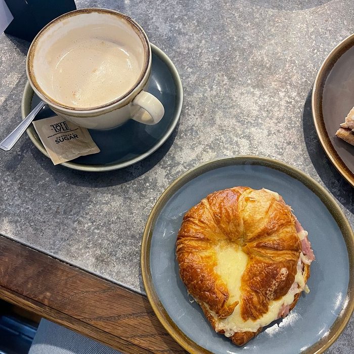 Flat white and ham and cheese croissant at Toast Coffee House